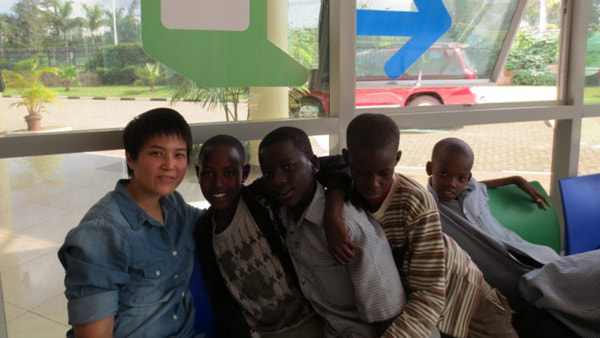 Juliana with local children while in Rwanda.